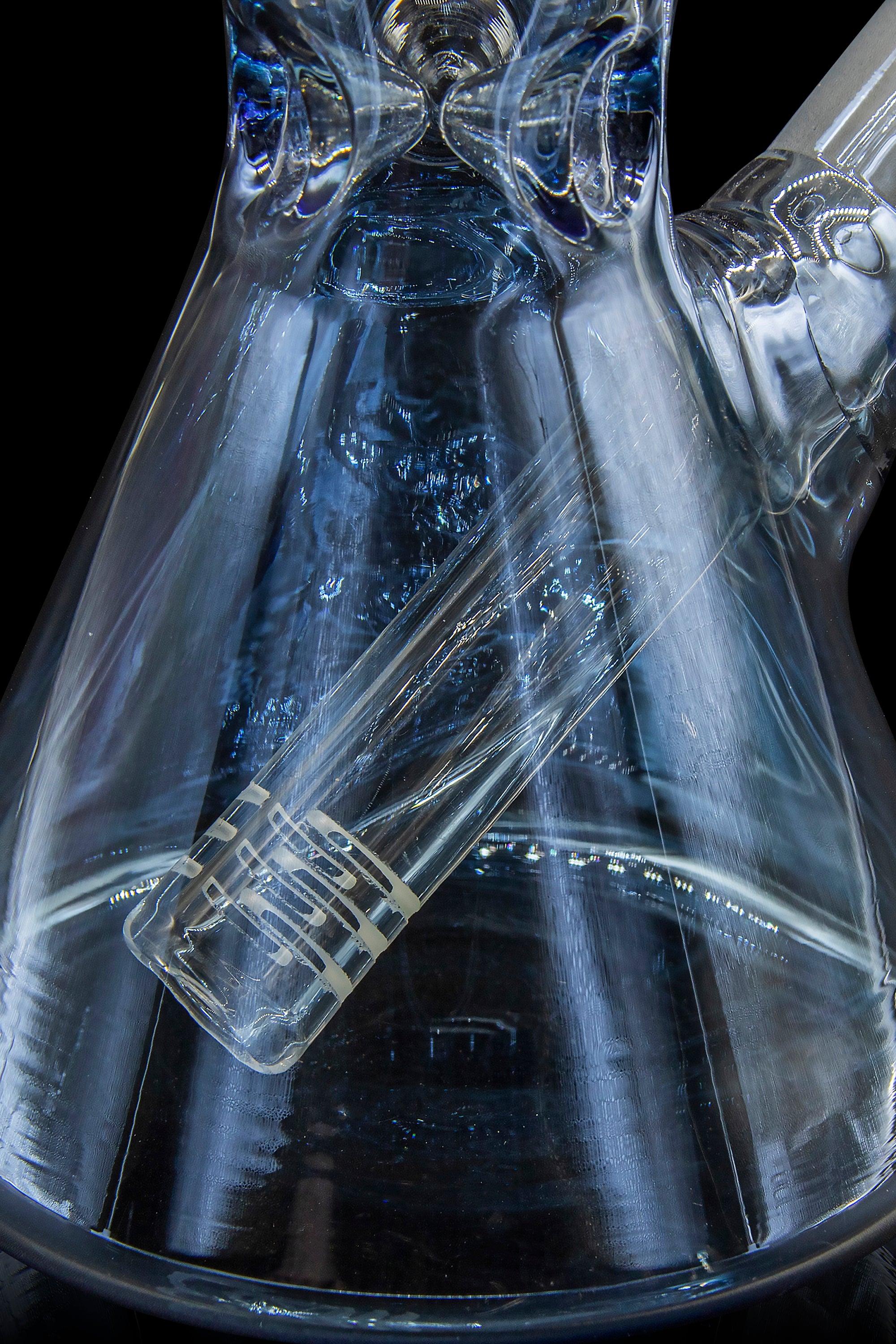 Blue glass cannabis water pipe with intricate swirling patterns.