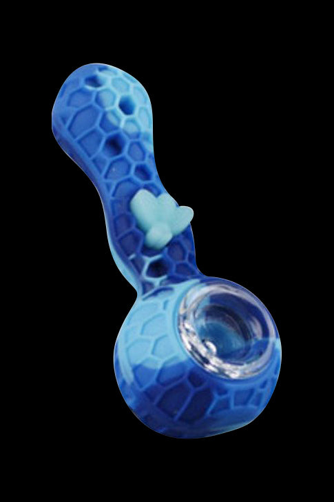 Angled view of a blue Silicone Bee Durable Hand Pipe with honeycomb texture and a small heart-shaped thumb rest against a black background.