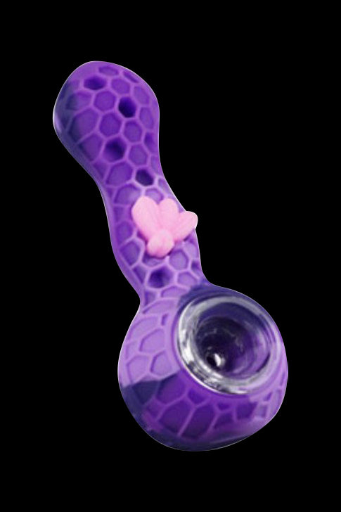 Angled close-up of the Silicone Bee Durable Hand Pipe showing its purple honeycomb-textured body and pink bee accent against a black background.