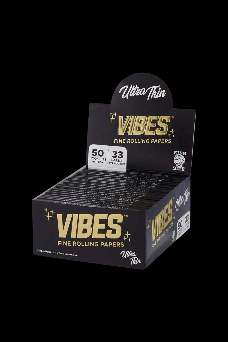 A close-up, angled view of VIBES King Size Slim Ultra Thin Rolling Papers, showcasing the branded packaging and booklet count.