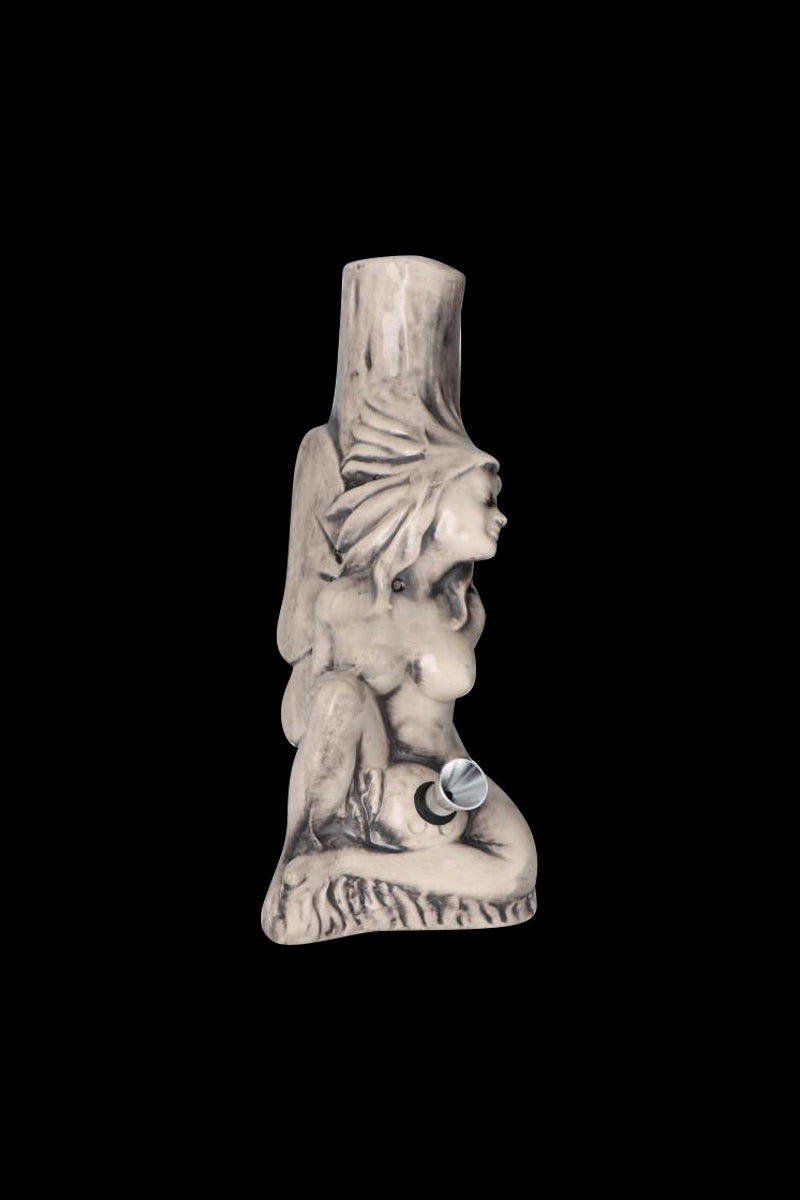 Center-frontal view of the Sleeping Maiden with Water Jug Ceramic Pipe showing a pale sculpted reclining female figure against a black background.