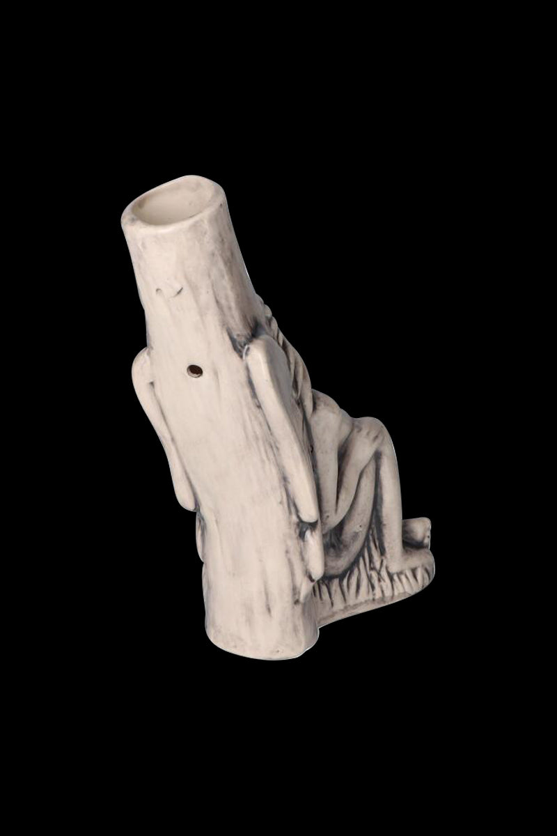 Angled view of the Sleeping Maiden with Water Jug Ceramic Pipe showing a pale, weathered maiden reclining against a hollow jug on a black background