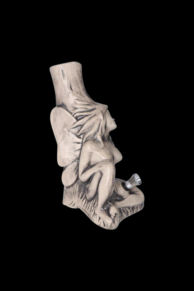 Side view of the Sleeping Maiden with Water Jug Ceramic Pipe showing a seated reclining maiden sculpted in pale ceramic against a black background.