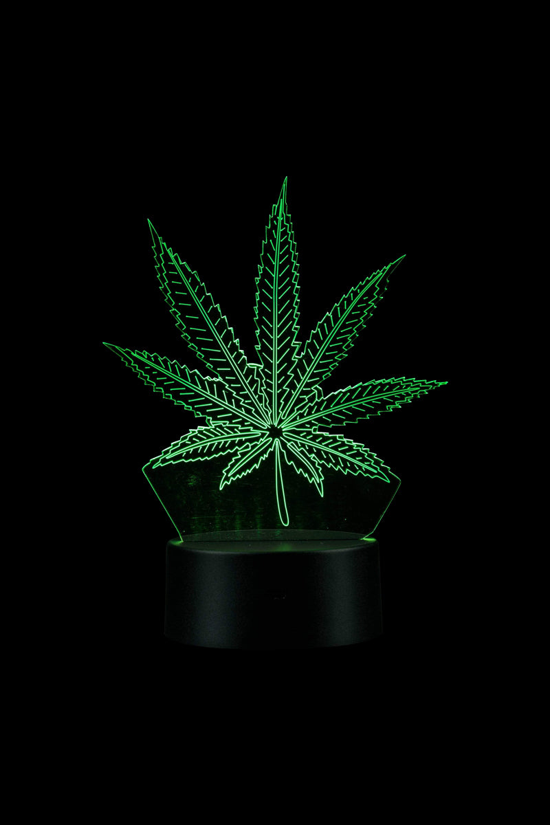 A front view of the 3D Cannabis Leaf Lamp, showing a detailed green leaf design atop a black cylindrical base.