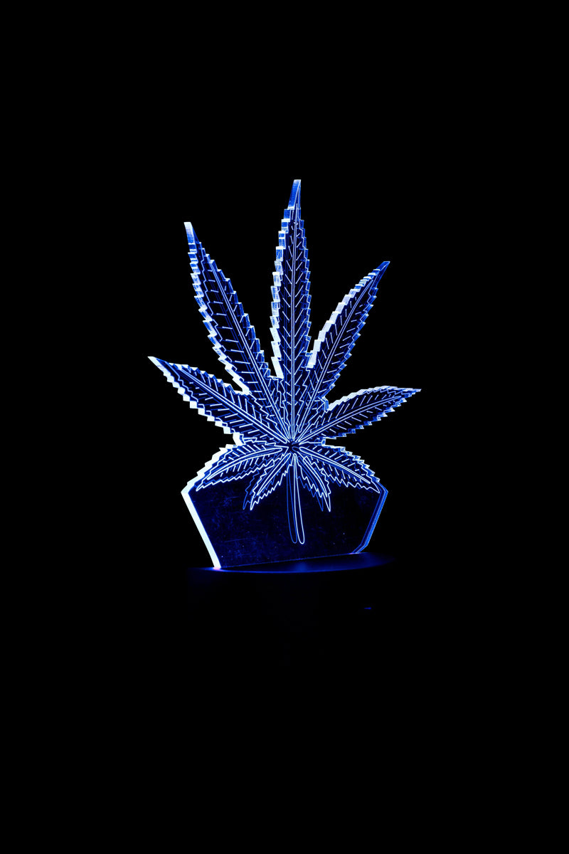 A slightly angled view of the 3D Cannabis Leaf Lamp, showcasing its illuminated, sculptural design.