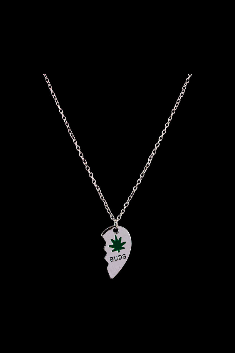 A close-up of the DankStop Best Buds Sharable Necklace, featuring two interlocking pendants on a delicate silver chain.
