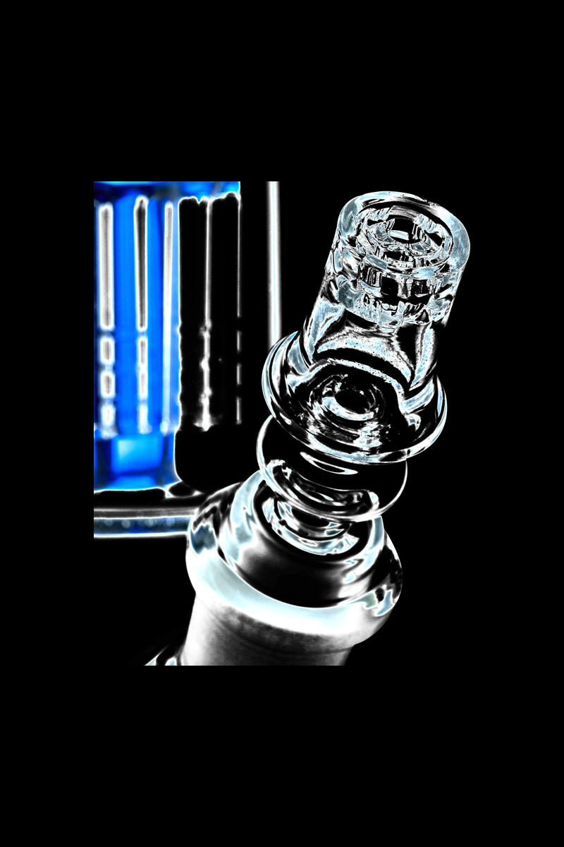 Close-up angled view of a clear glass Diamond Knot Domeless Nail against a black background with blue-lit reflections.