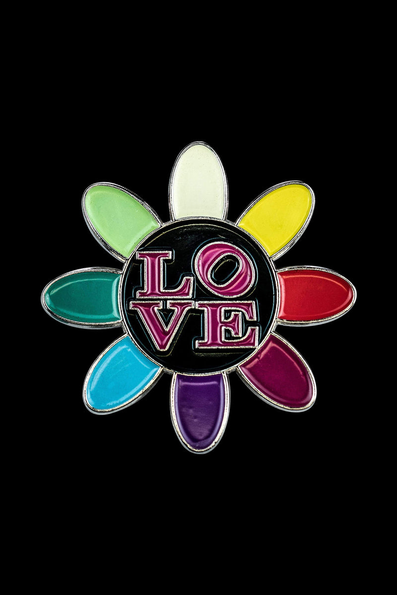 A close-up of the Love Daisy Metal Pin, showcasing its colorful petal arrangement with a metallic sheen.