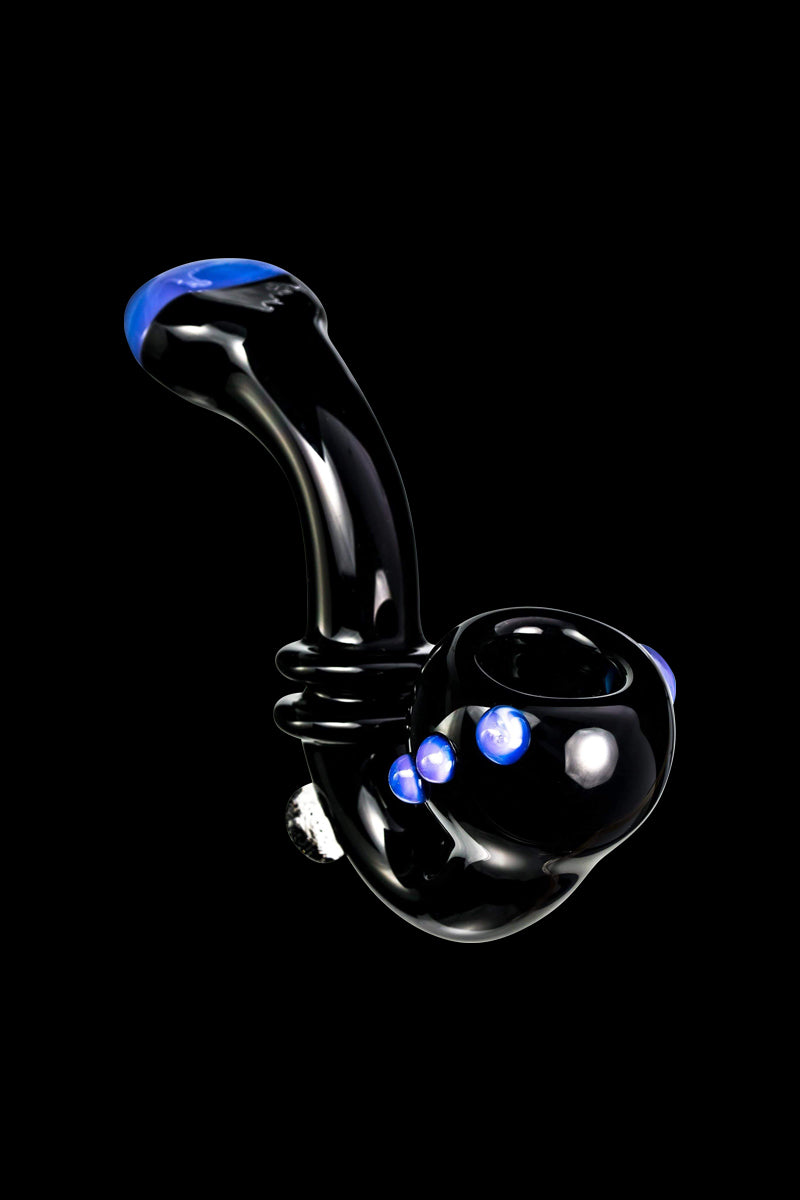 Angled close-up of the Maria Ring Sherlock Pipe in glossy black glass with blue accents and three blue glass marbles on the bowl.