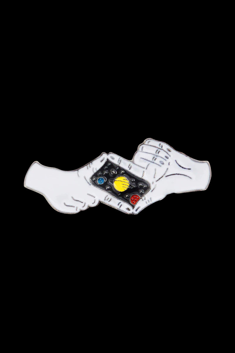 A close-up of the Picture The Universe Enamel Pin, depicting a colorful celestial scene on a dark background.