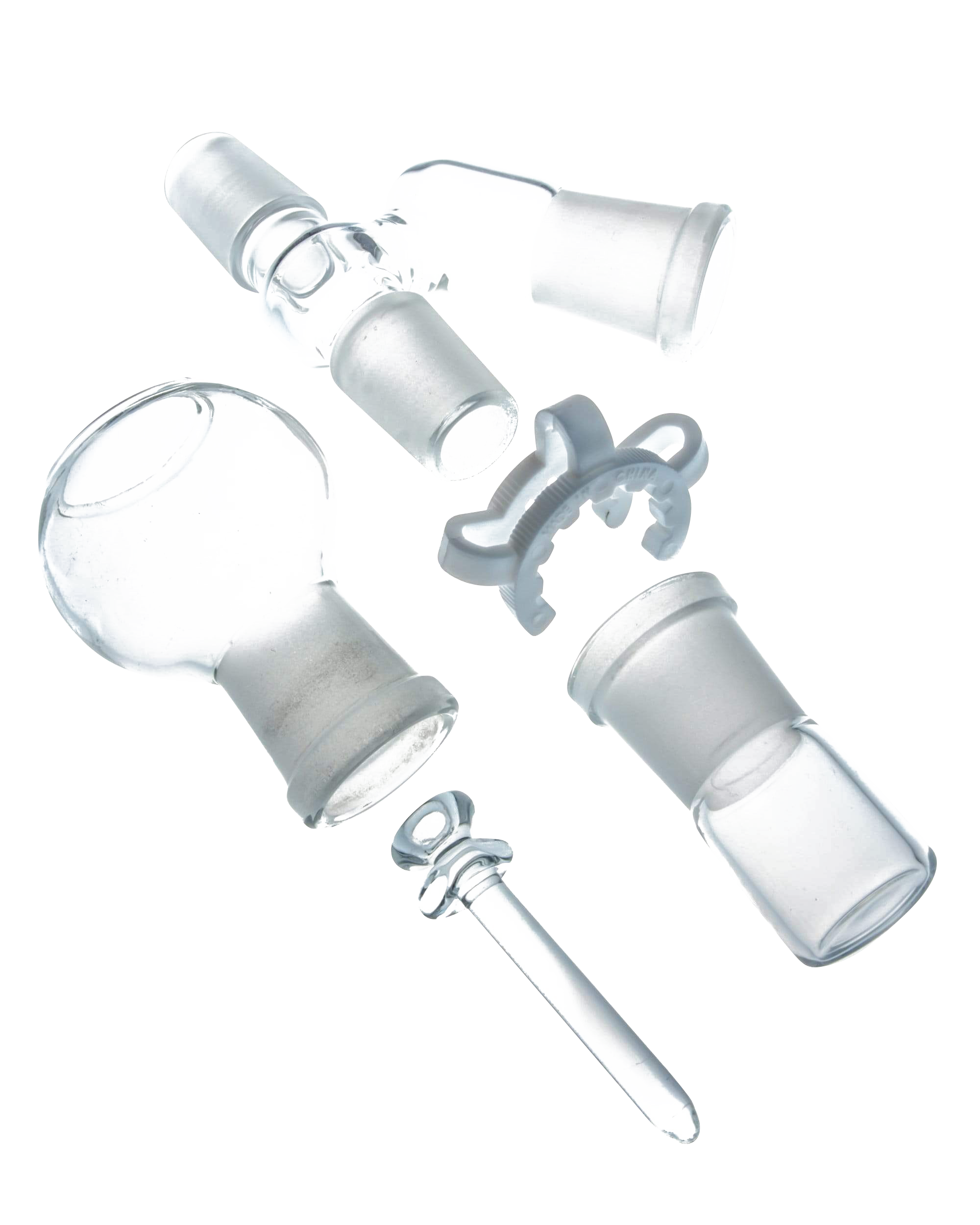 Angled close-up of clear glass fittings and a small plastic clip against black showing the Reclaim Catcher.
