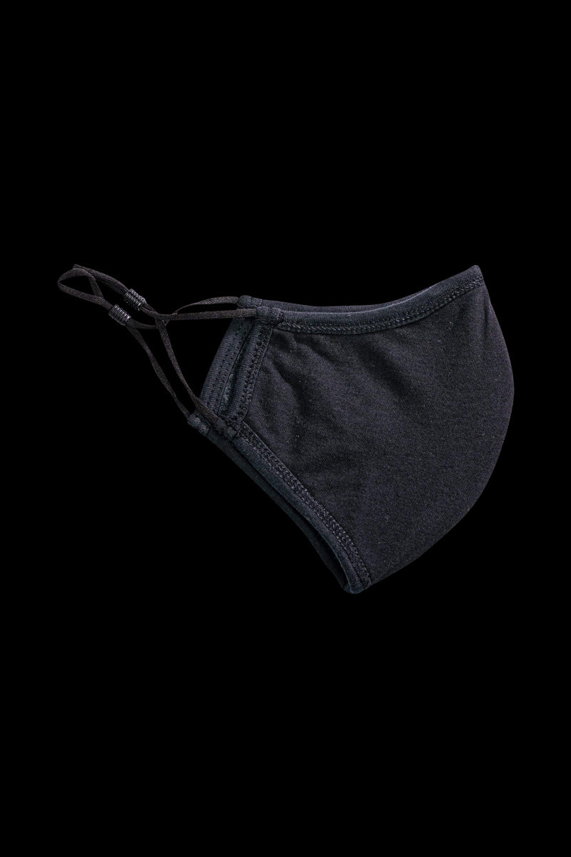 A slightly angled close-up of the Reversible Cloth Mask, showcasing its simple, folded fabric design against a plain white background.