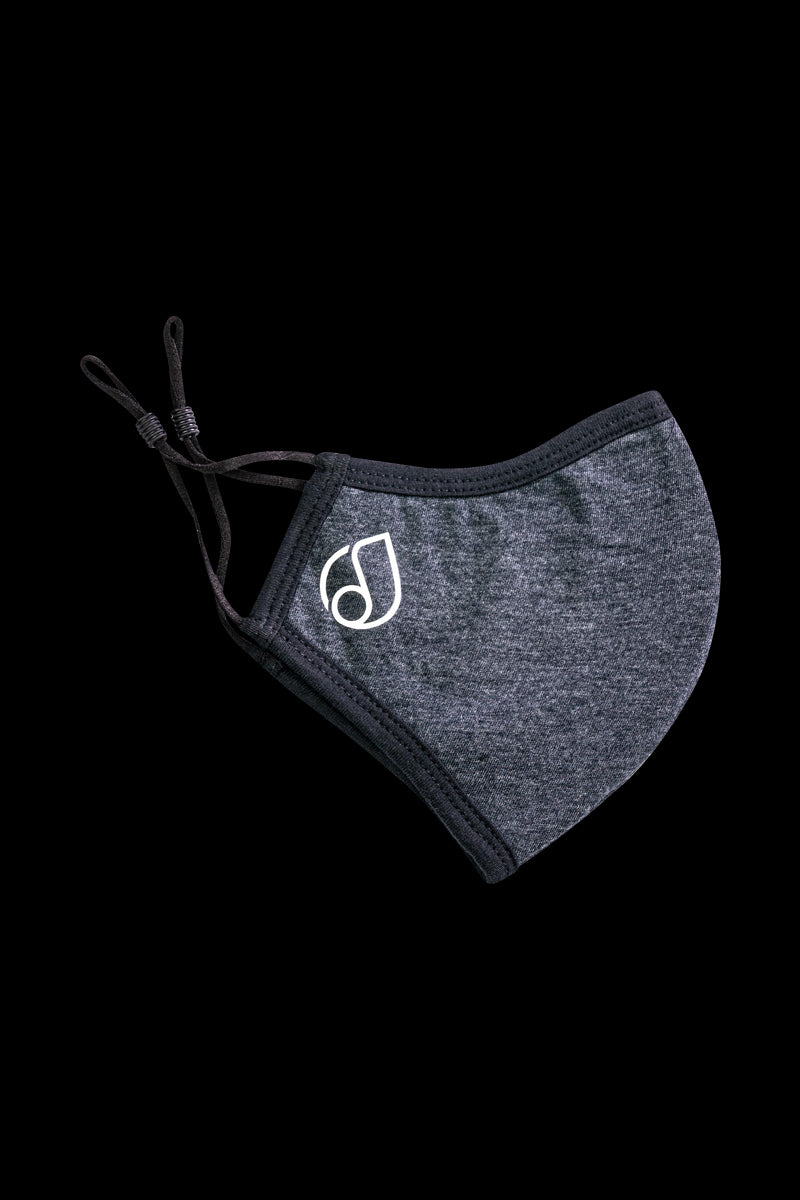 Close-up of the Reversible Cloth Mask, a dark-colored fabric face covering against a plain background.