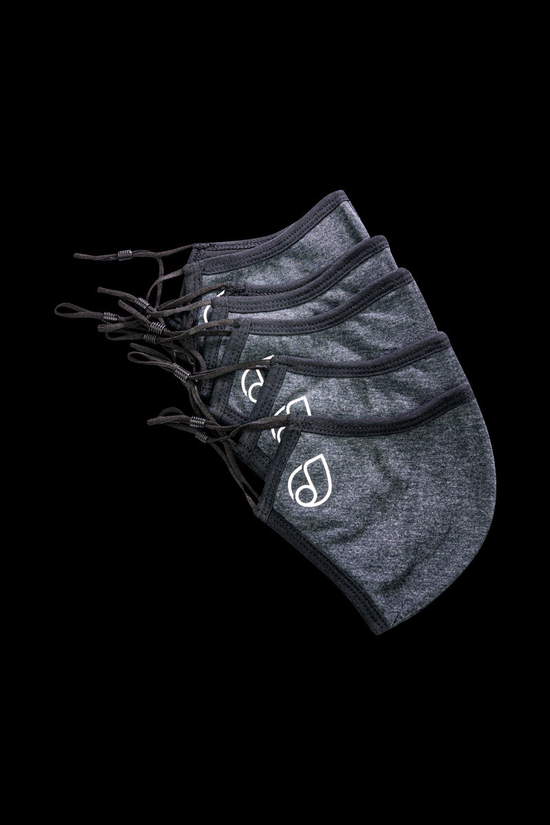 Close-up of the Reversible Cloth Mask, displaying a simple, folded design against a dark gray background.