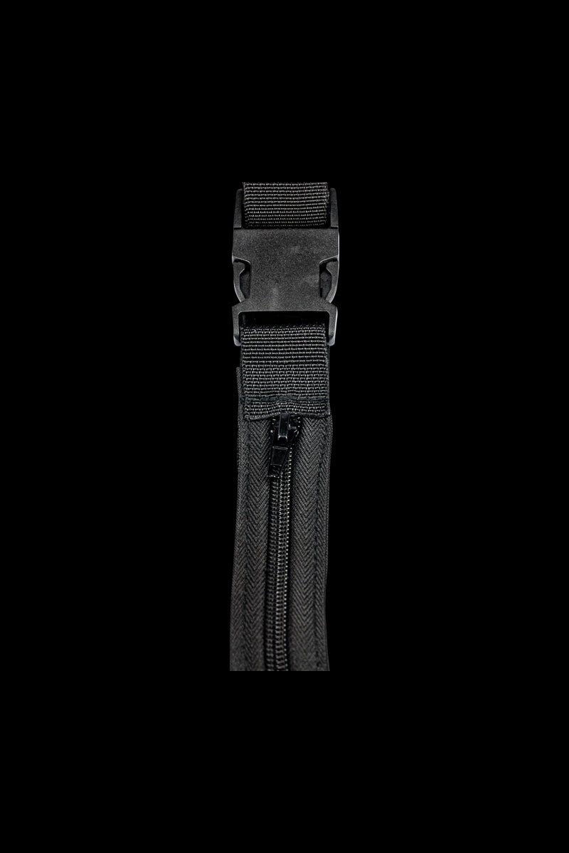 A close-up, angled view of the Secret Stash Belt featuring a black buckle and woven strap texture.