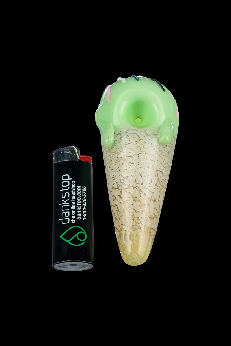 A close-up shows the Single Scoop Ice Cream Spoon Pipe with a glossy finish and curved design, angled against a dark background.