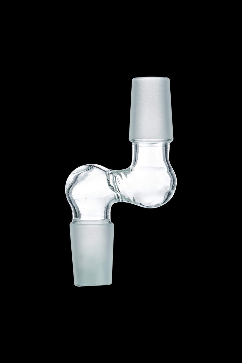 Center-lit close-up of the Step Up 90° Male to Male Adapter showing its clear glass S-shaped elbow and frosted male joints against a black background