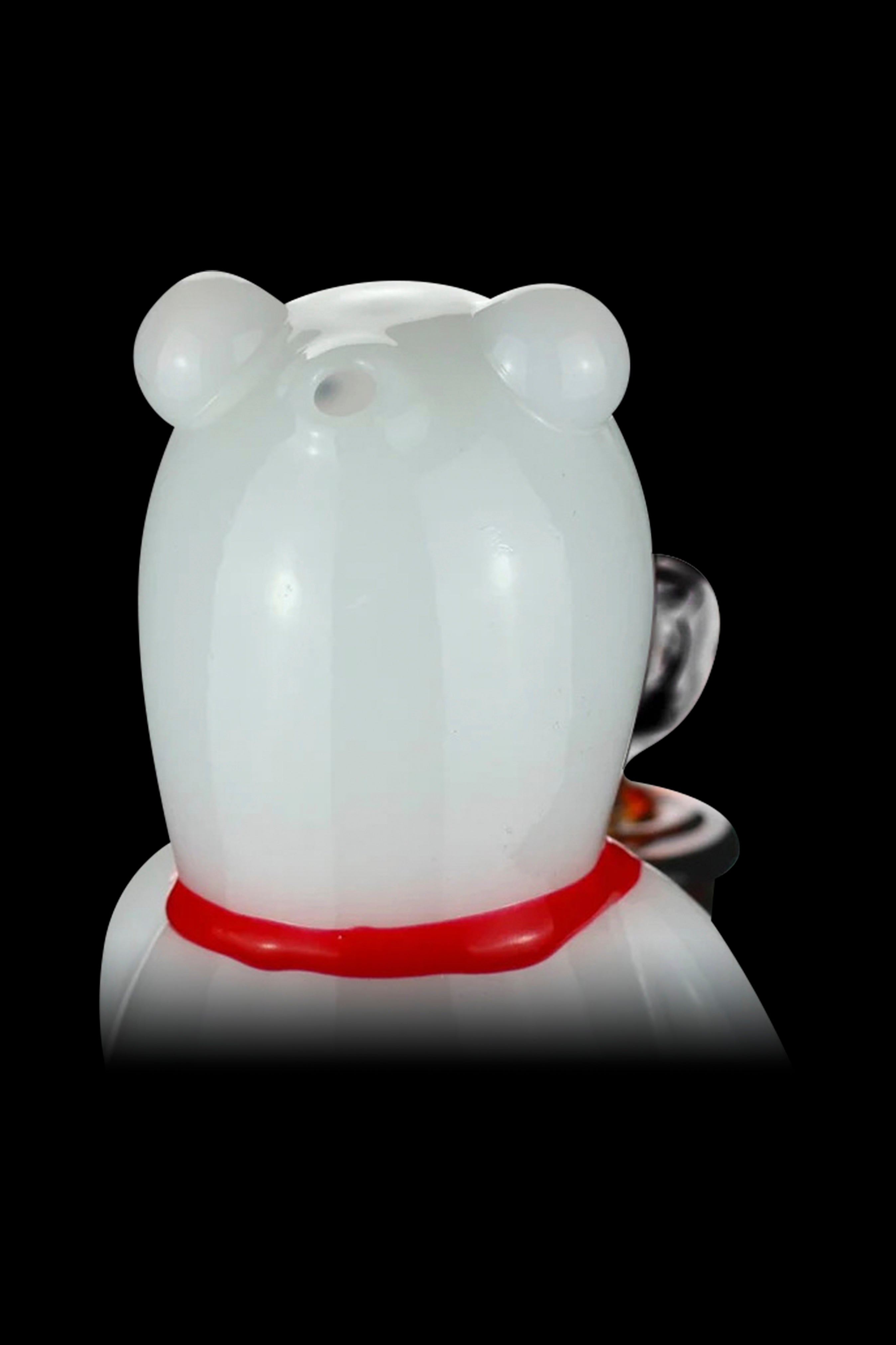 White glass pipe shaped like a bear with a red collar.