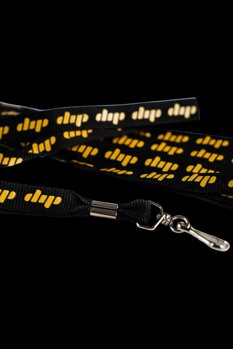 A close-up view of the Dip Devices Lanyard with a silver clasp, hanging against a dark background.