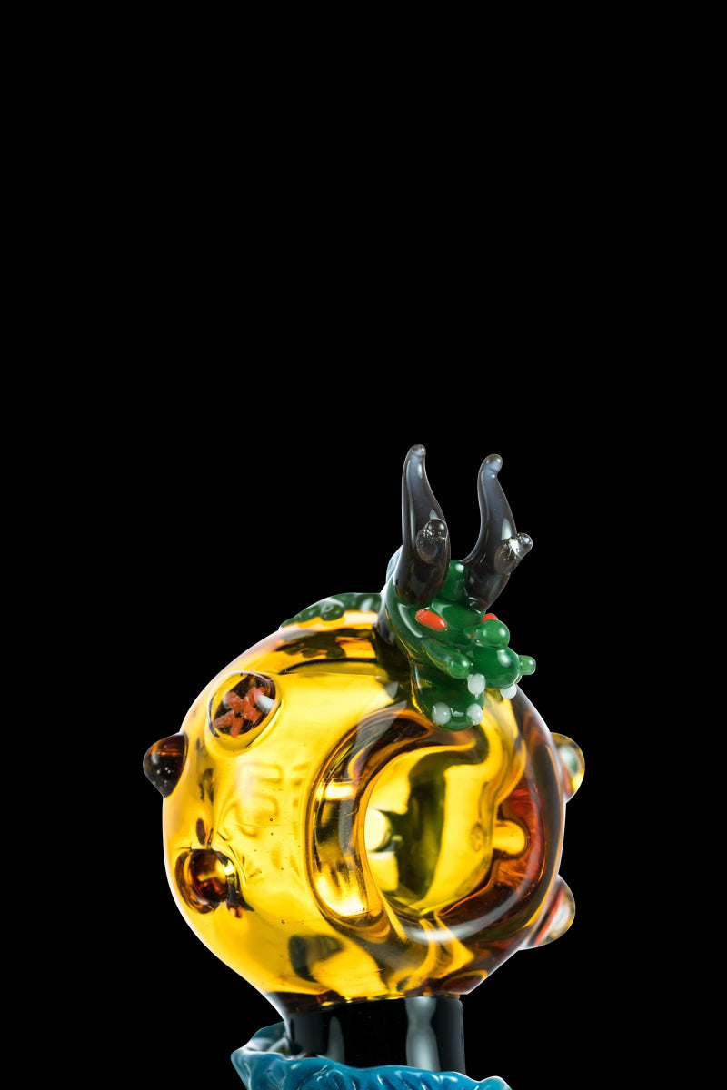 The Empire Glassworks Dragon Sphere Small Spoon Pipe is shown in a close-up, angled view against a dark backdrop.