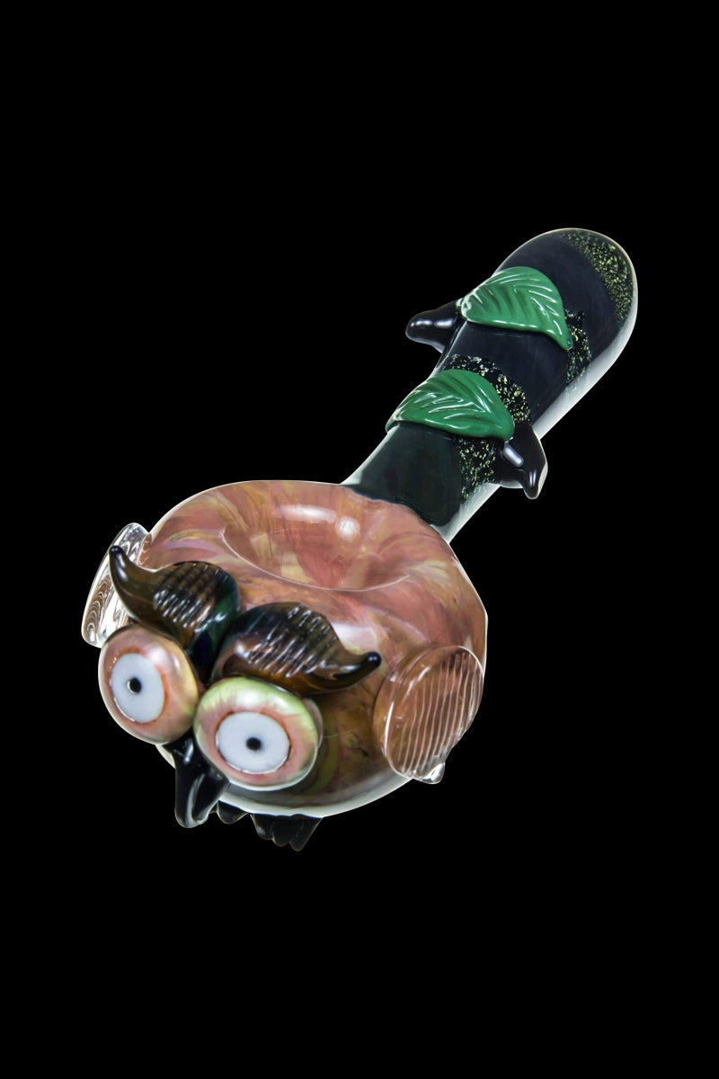 A detailed side view of the Empire Glassworks "The Owl" Mini Glass Spoon Pipe, featuring sculpted owl facial details in vibrant colors.