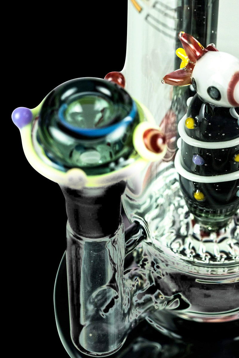 A close-up, angled view of the Empire Glassworks Galactic Flagship Bong with a clear glass construction and unique patterned accents.