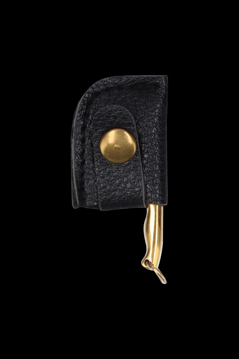 Close-up of the THGC EX II Mini Chopping Knife with Cover showing a black leather sheath with brass snap and the gold-toned knife tip peeking out.