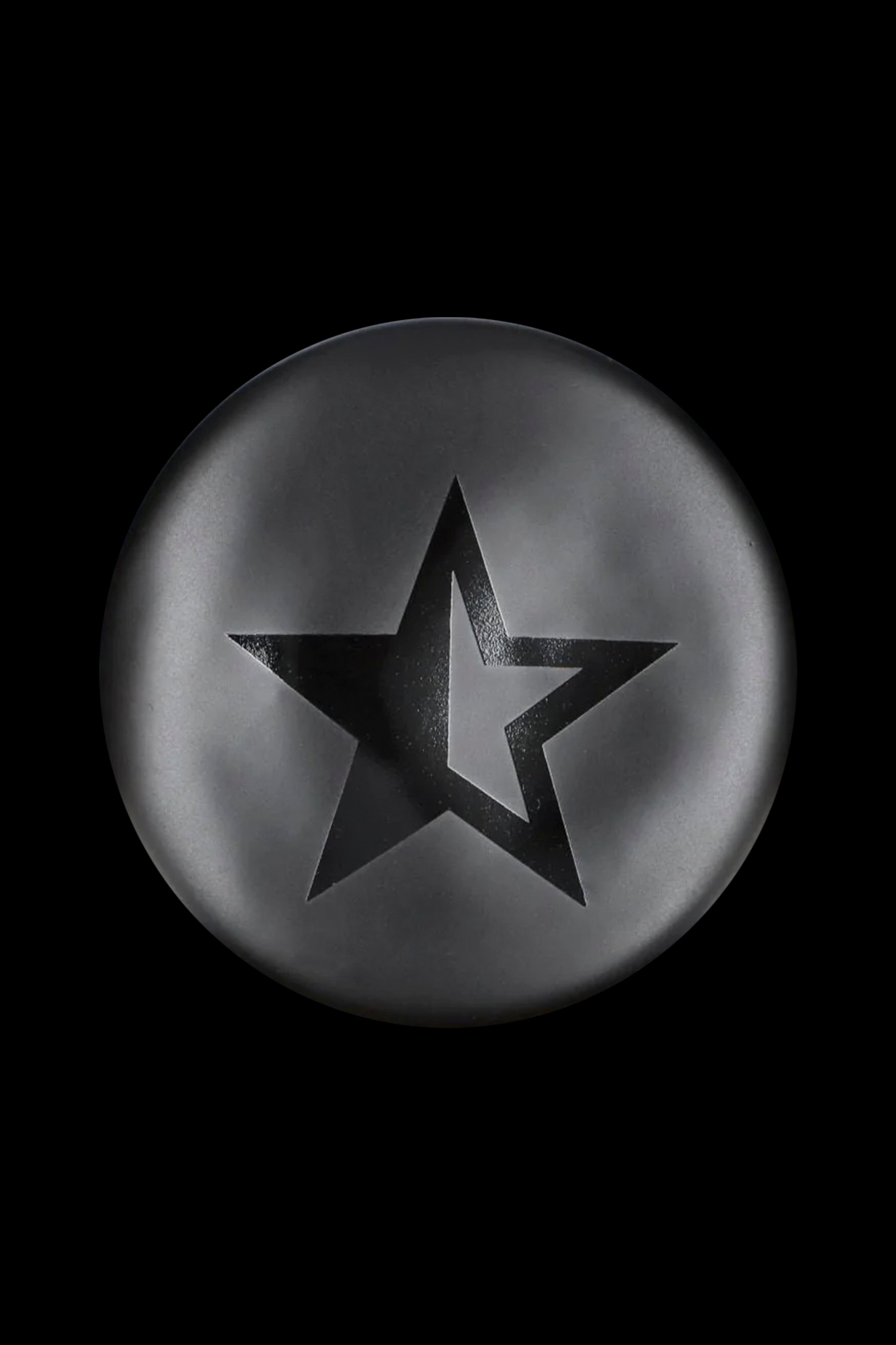 Black star-shaped emblem on a metallic gray circular background.
