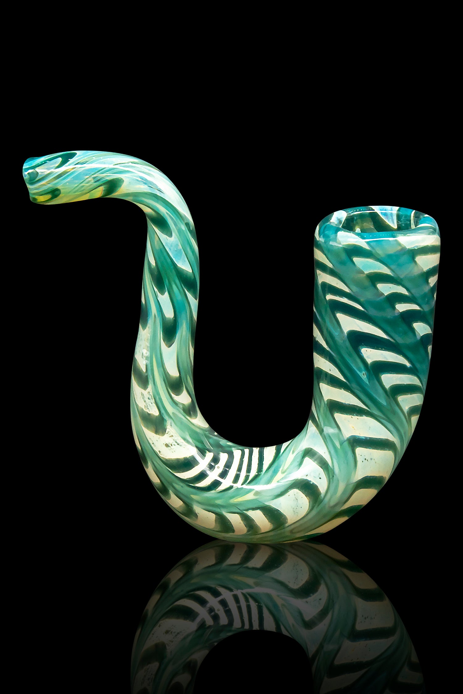 Hand-blown glass cannabis pipe with swirling green and white patterns, reflected on a black surface.