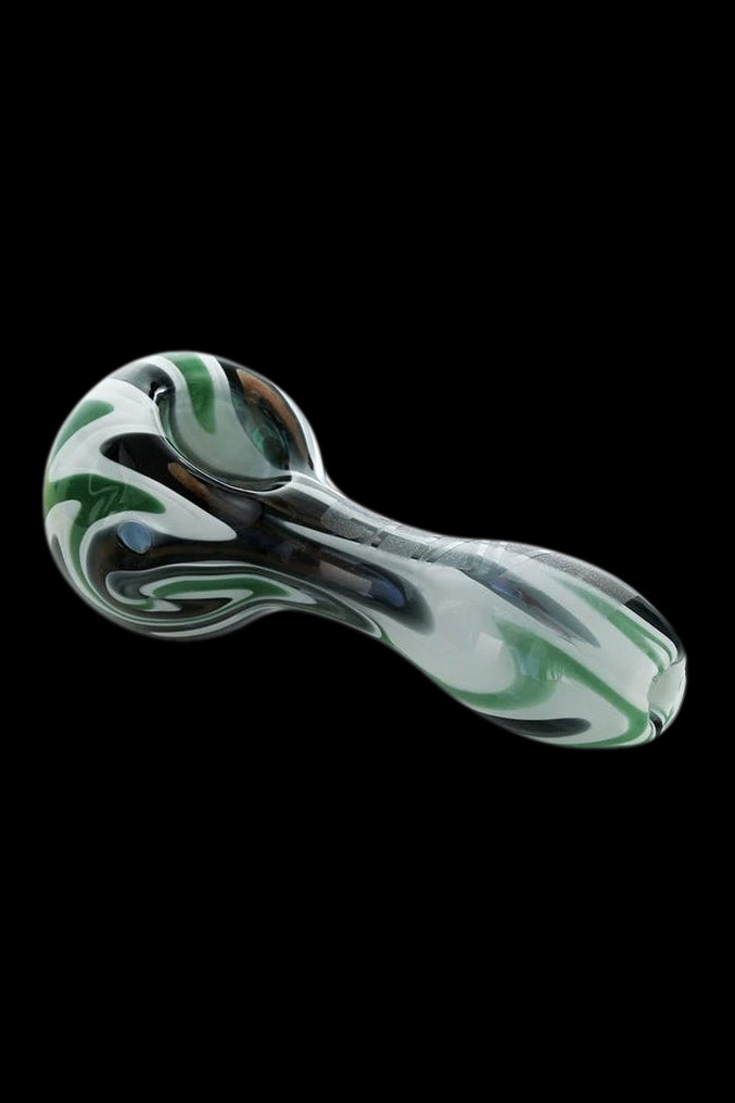 Glass pipe with swirling green and white patterns on a black background.