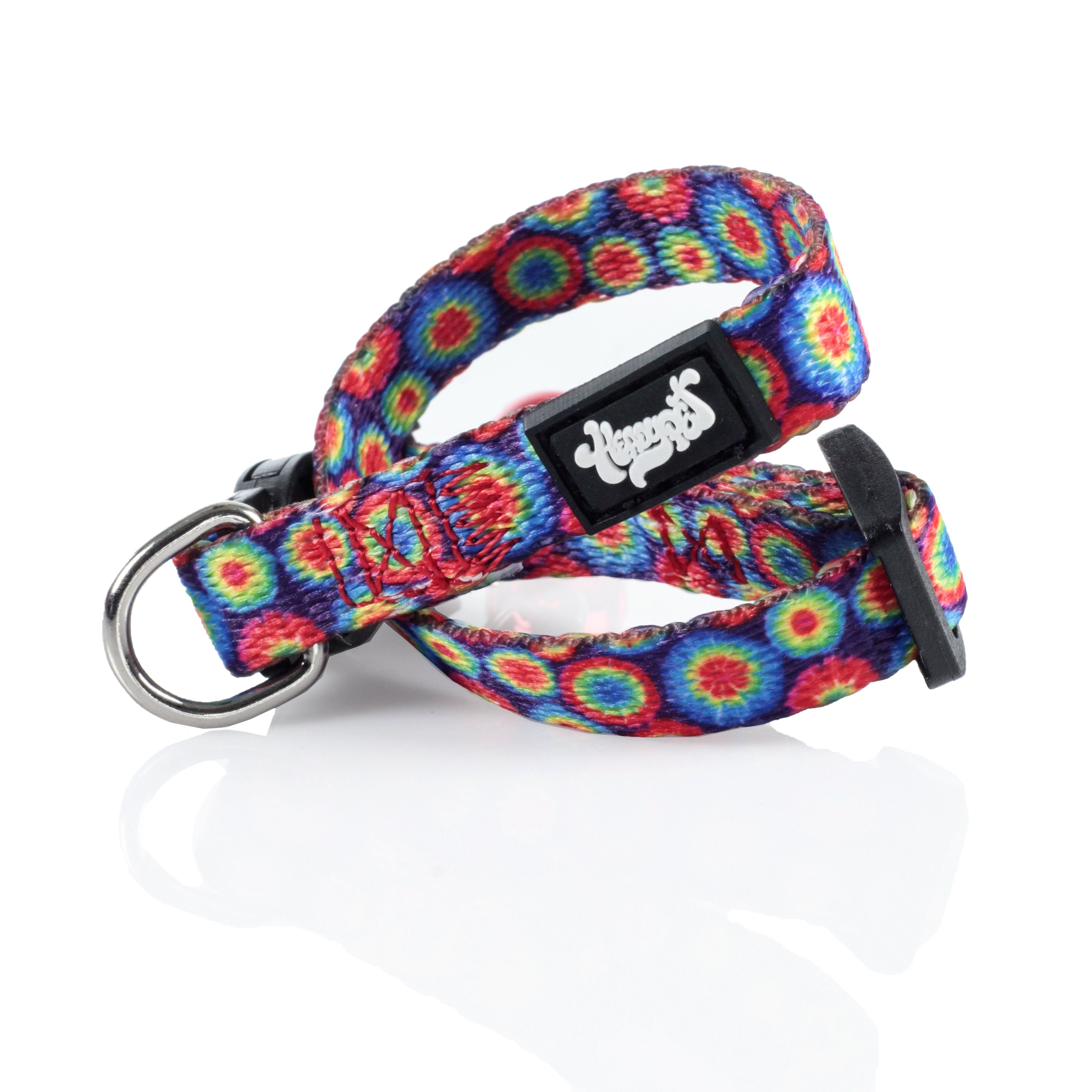 A close-up, angled view of the HeadyPet Cat Collar, showcasing its vibrant, patterned design against a bright, white background.