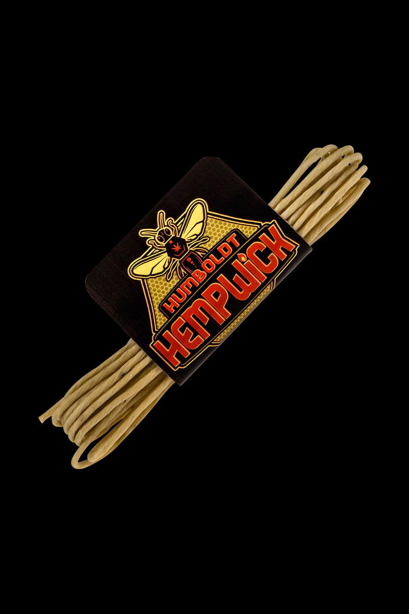 Angled close-up of a bundled hemp wick with a black label reading Humboldt Hemp Wick Full Flame against a black background.