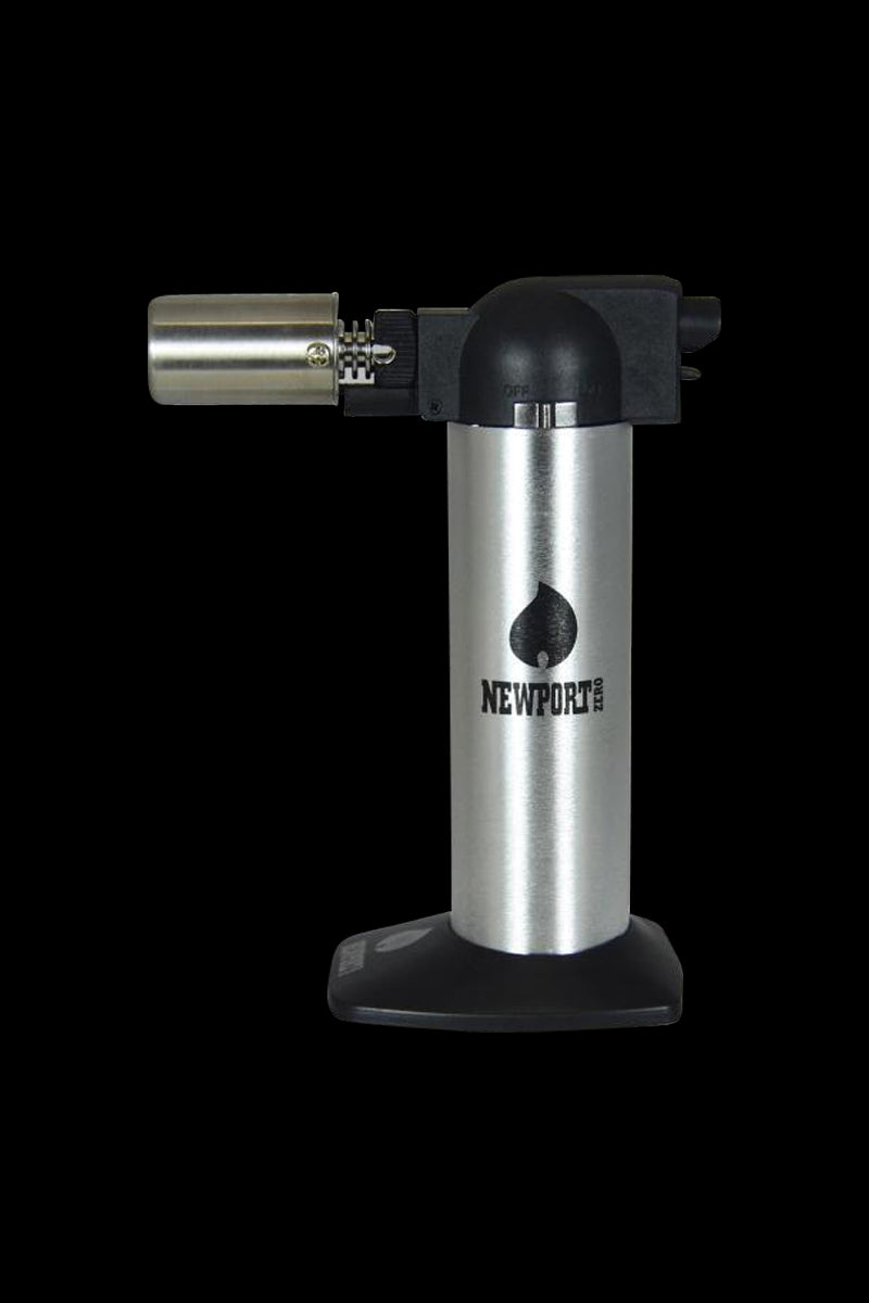 Centered front view of the Newport Butane Torch Lighter - 6 Inch showing its silver cylindrical body, black plastic top and wide base against a black background