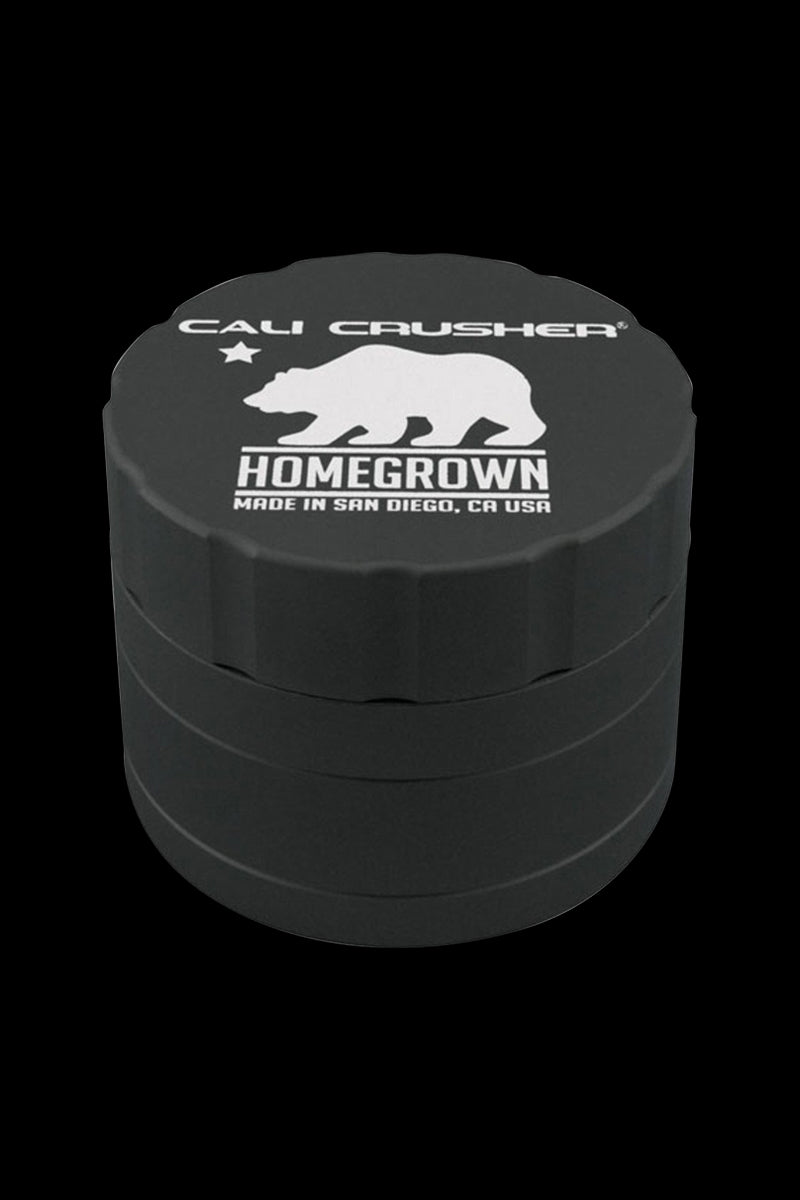Close-up front view of the grey Cali Crusher Homegrown 4-Part Grinder showing its stacked cylindrical sections and white bear logo.