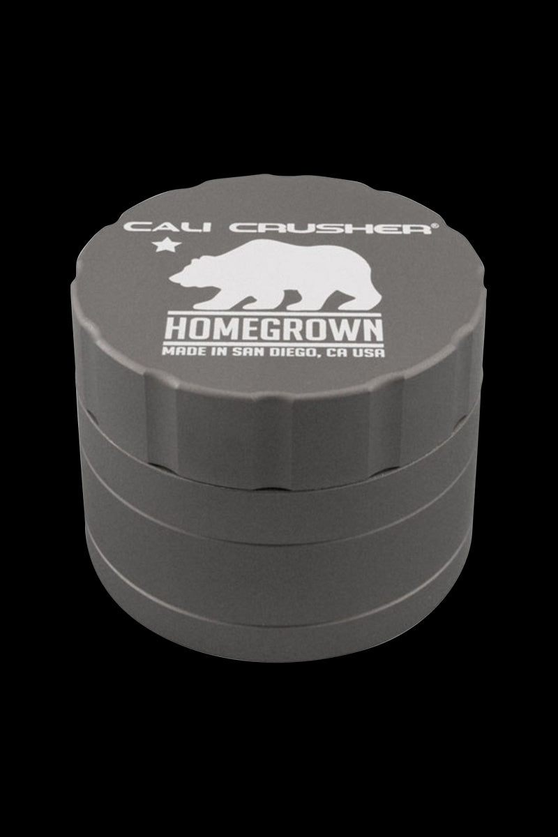 Top-down view of the Cali Crusher Homegrown 4-Part Grinder showing its red ridged lid with a white bear logo and stacked chamber profile.