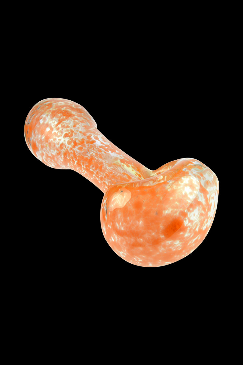 Angled close-up of the Glassheads Spoon Pipe with Scatter Frit showing its orange-and-white speckled glass against a black background