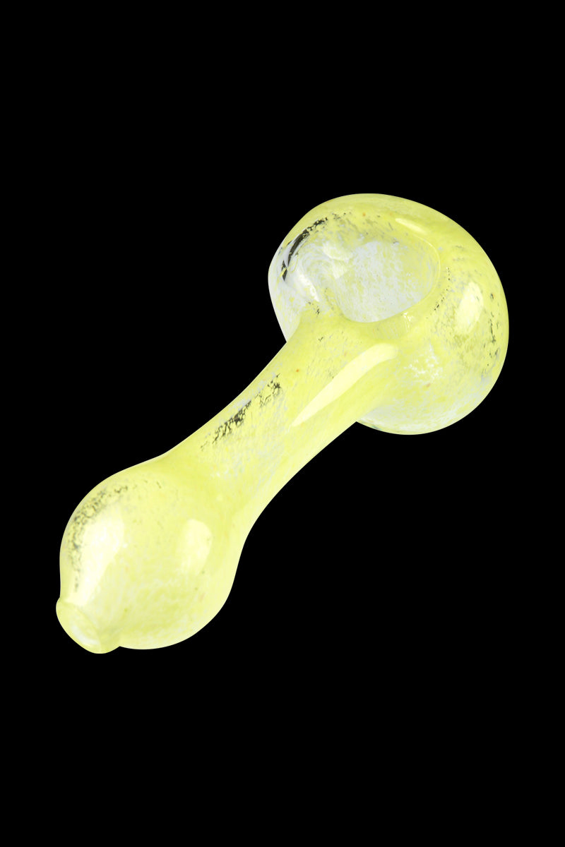 Diagonal top-down view of a yellow Glassheads Spoon Pipe with Scatter Frit against a black background, showing its rounded bowl and tapered handle.