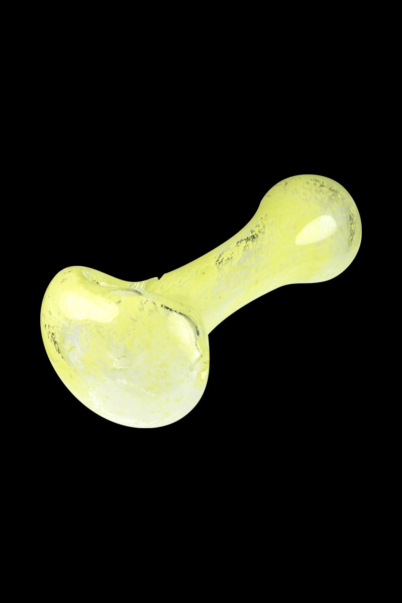 Angled close-up of the Glassheads Spoon Pipe with Scatter Frit in pale yellow glass against a black background.