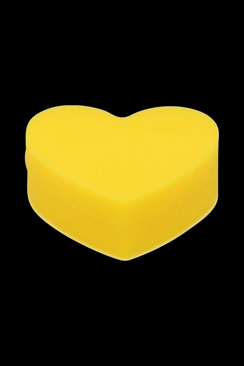 Close-up front view of a bright yellow Silicone Heart Stash Container centered on a solid black background.
