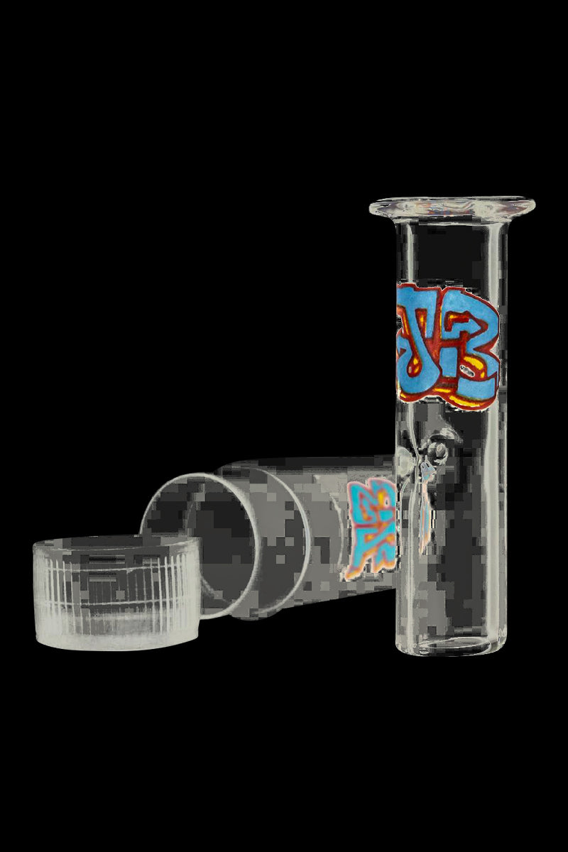 Close-up, three-quarter view of a clear Jerome Baker Designs Glass Filter Tip with colorful graffiti-style decal against a black background.