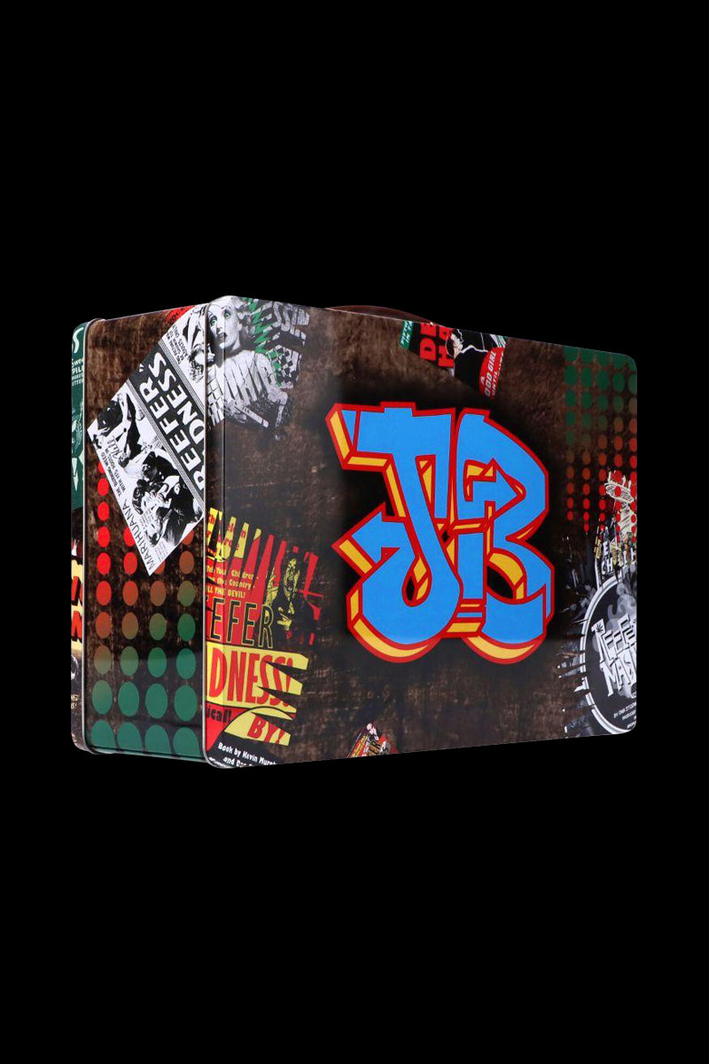 Three-quarter view of the Jerome Baker Lunch Box against a black background featuring a large blue and red graffiti-style "JB" and collage posters.