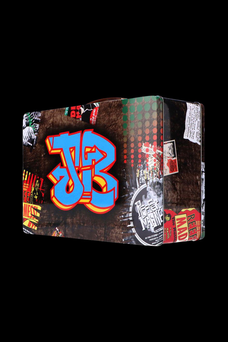 Angled front view of the Jerome Baker Lunch Box with a large blue and red graffiti "JB" on a collage-style dark background