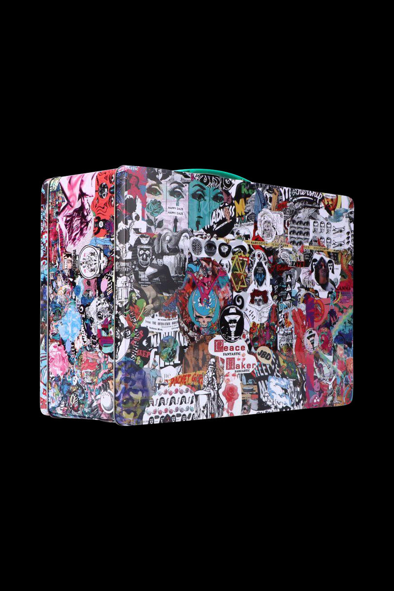 Angled view of a collage-covered Jerome Baker Lunch Box with colorful stickers and street-art graphics against a black background.