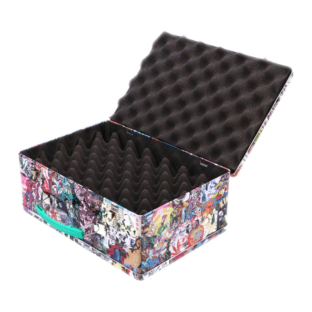 Angled top-down view of the open Jerome Baker Lunch Box showing egg-crate black foam lining and a colorful collage exterior with a teal handle