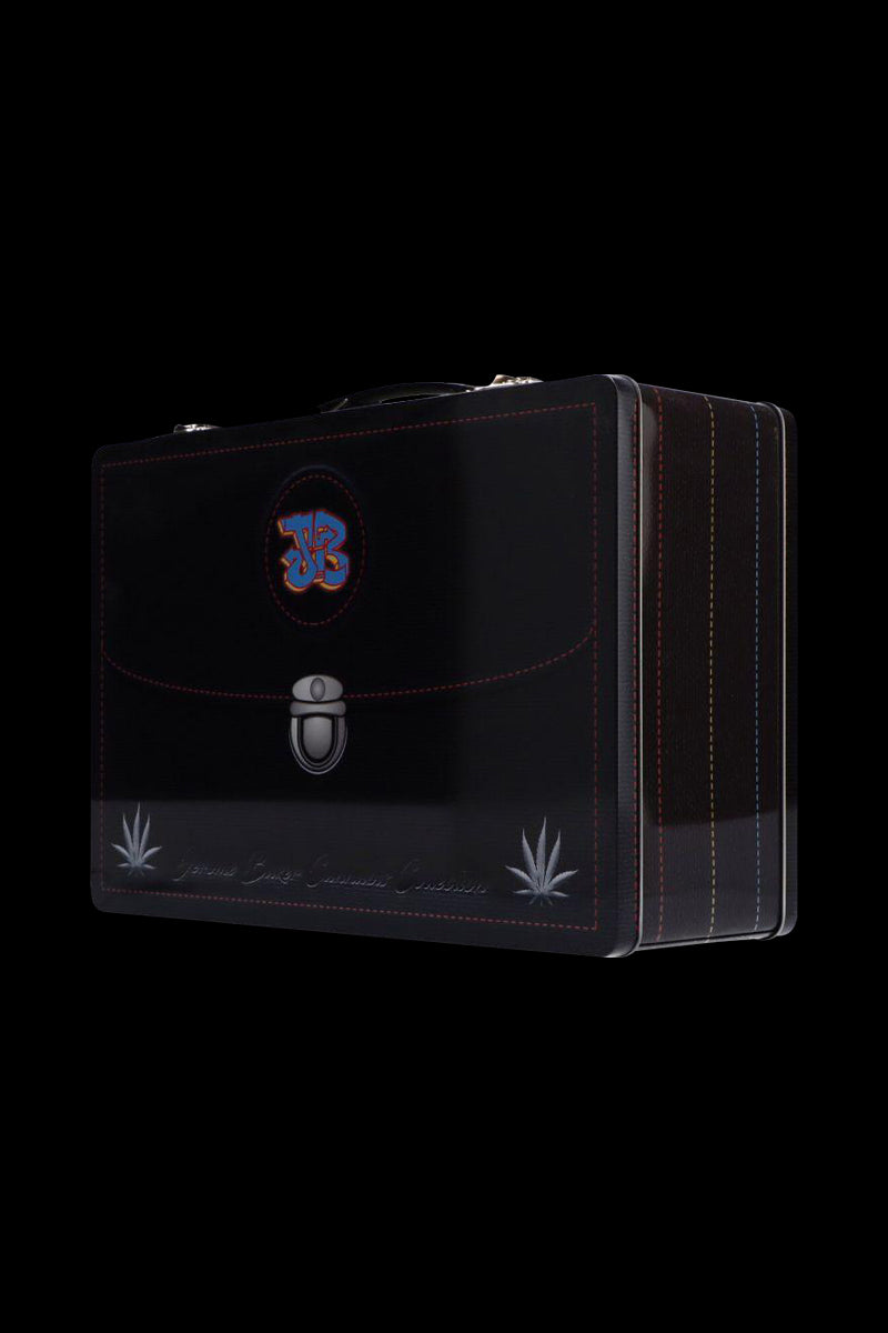 Angled three-quarter view of a black Jerome Baker Lunch Box with stitched edges, emblem on the flap, and silver clasp against a black background