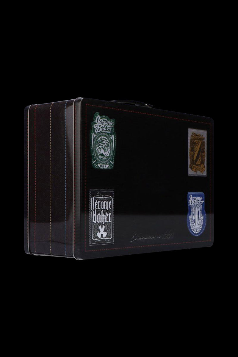 Three-quarter view of a black Jerome Baker Lunch Box with stitched edges and four decorative vintage-style stickers on its front.