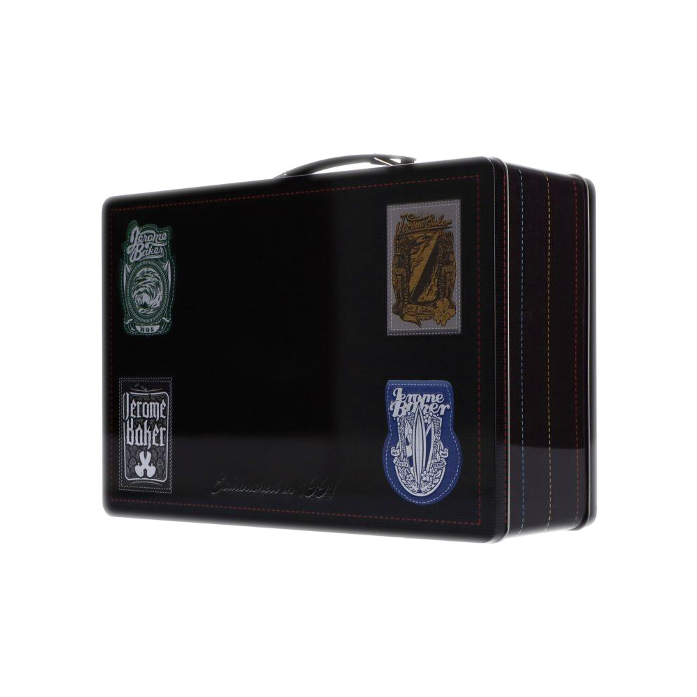 Angled view of a glossy black Jerome Baker Lunch Box adorned with four colorful stitched patches and a top handle.