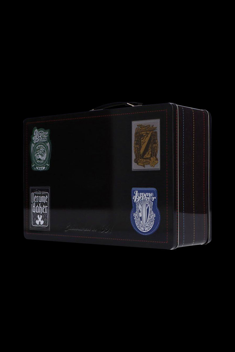 Three-quarter view of a black Jerome Baker Lunch Box with colorful stitched edges and four vintage-style logo patches on its front.