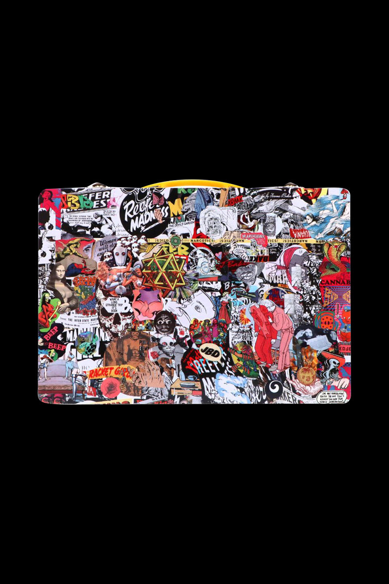 Front-facing view of the Jerome Baker Lunch Box covered in a dense, colorful collage of stickers and illustrations against a solid black background.