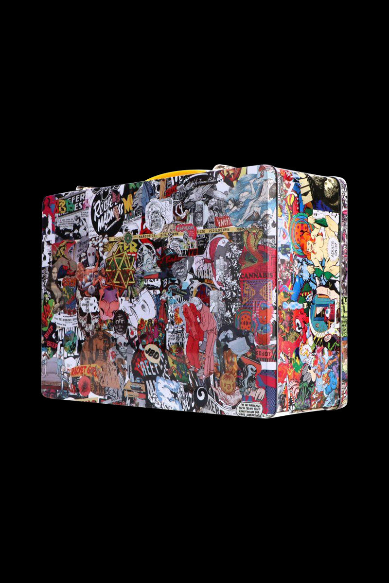 Angled view of a sticker-covered Jerome Baker Lunch Box with a yellow handle against a solid black background
